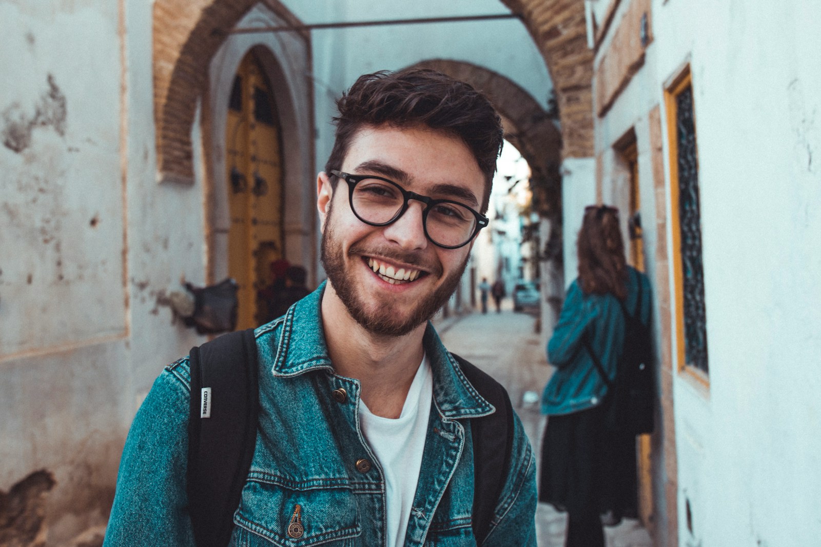 smiling man standing near building